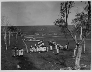 Girls in white dresses from Seversky Post walking to the church at Kazachi Post. Near East Relief worker Janet McKaye is on the far left. The original caption reads 