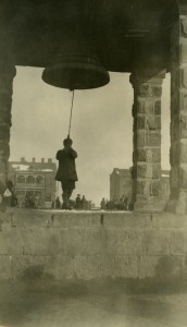 A boy rings the bell at the Polygon Orphanage in Alexandropol. Near East Relief workers installed the bell to call the children to class, meals, and bed.